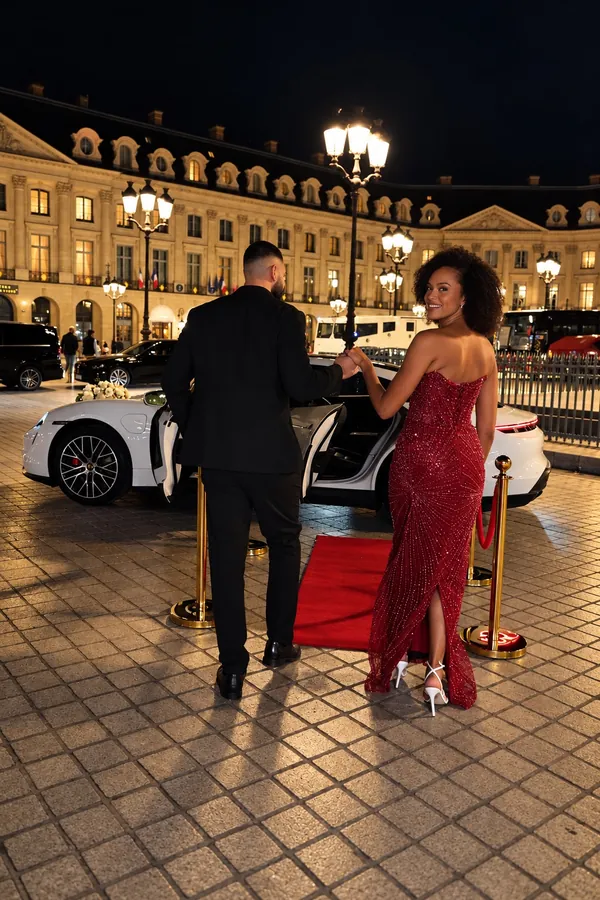 Couple devant la Porsche Taycan, place Vendôme